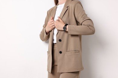 Photo of Woman in beige suit on white background, closeup