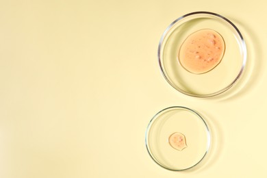 Photo of Petri dishes with samples on beige background, top view. Space for text