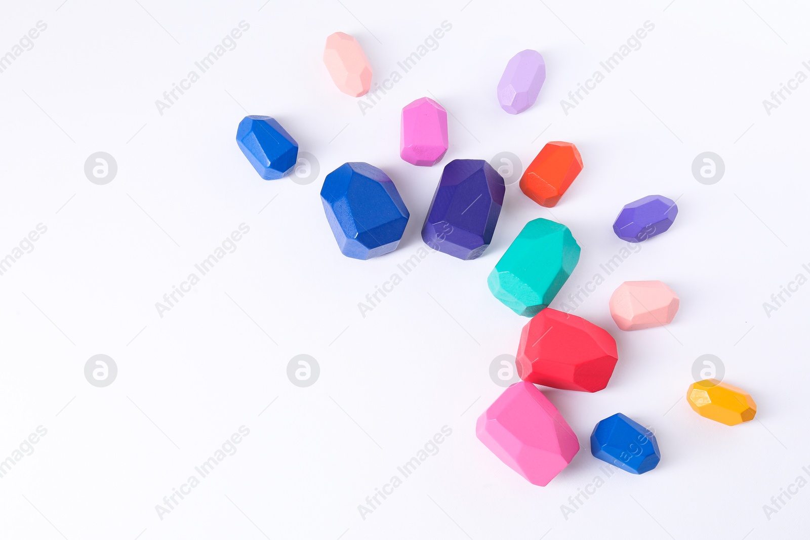 Photo of Many colorful balancing stones on white background, above view. Space for text