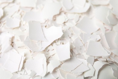 Photo of Pieces of broken eggshells as background, closeup