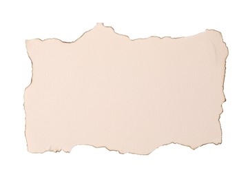 Photo of Piece of old paper with dark burnt borders isolated on white, top view