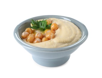 Delicious hummus with olive oil, chickpeas and parsley isolated on white