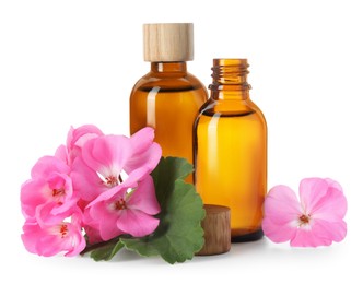 Photo of Geranium essential oil in bottles and beautiful flowers isolated on white