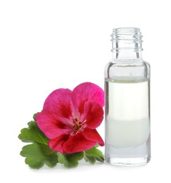 Photo of Geranium essential oil in bottle and beautiful flower isolated on white