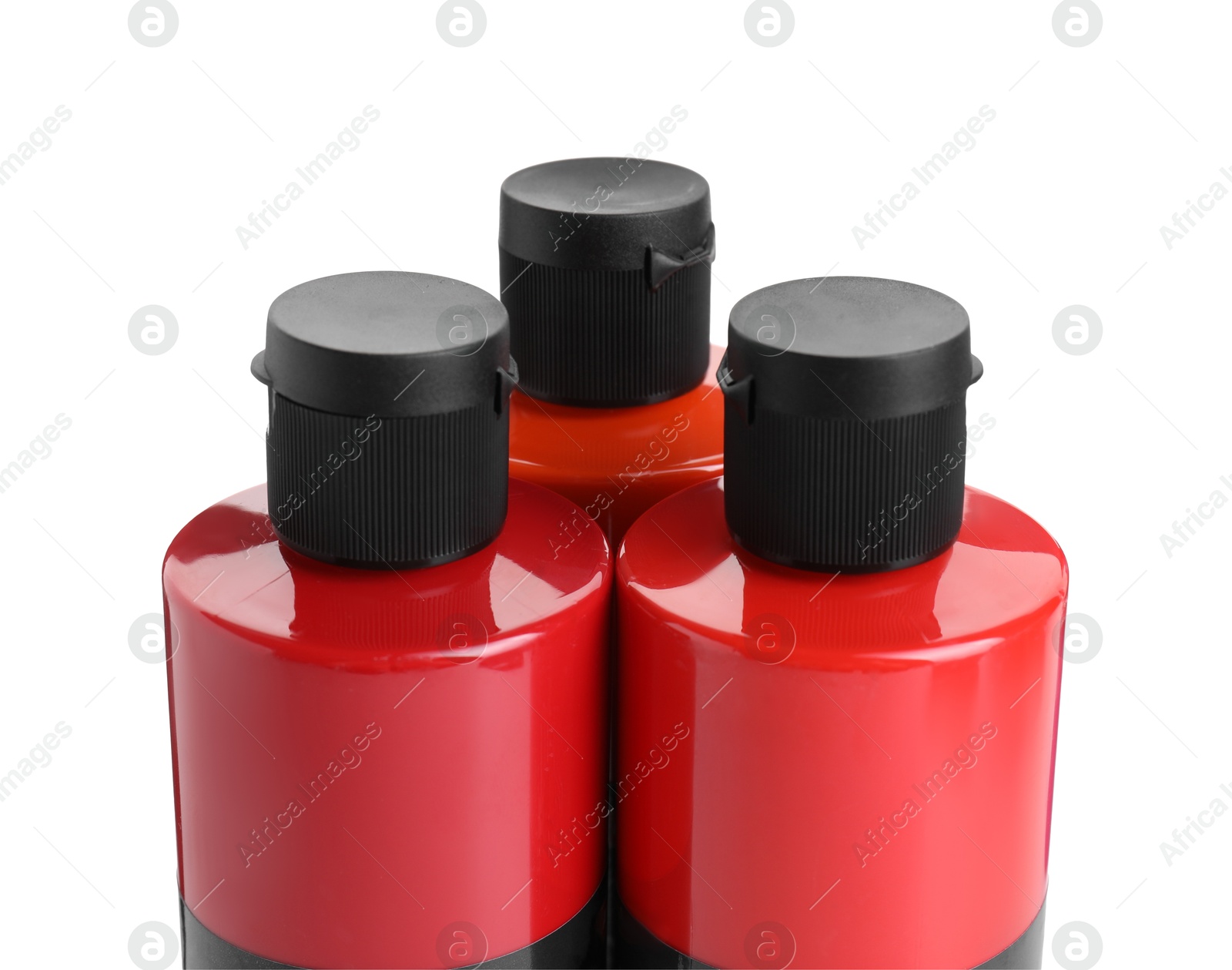 Photo of Red acrylic paints in bottles isolated on white