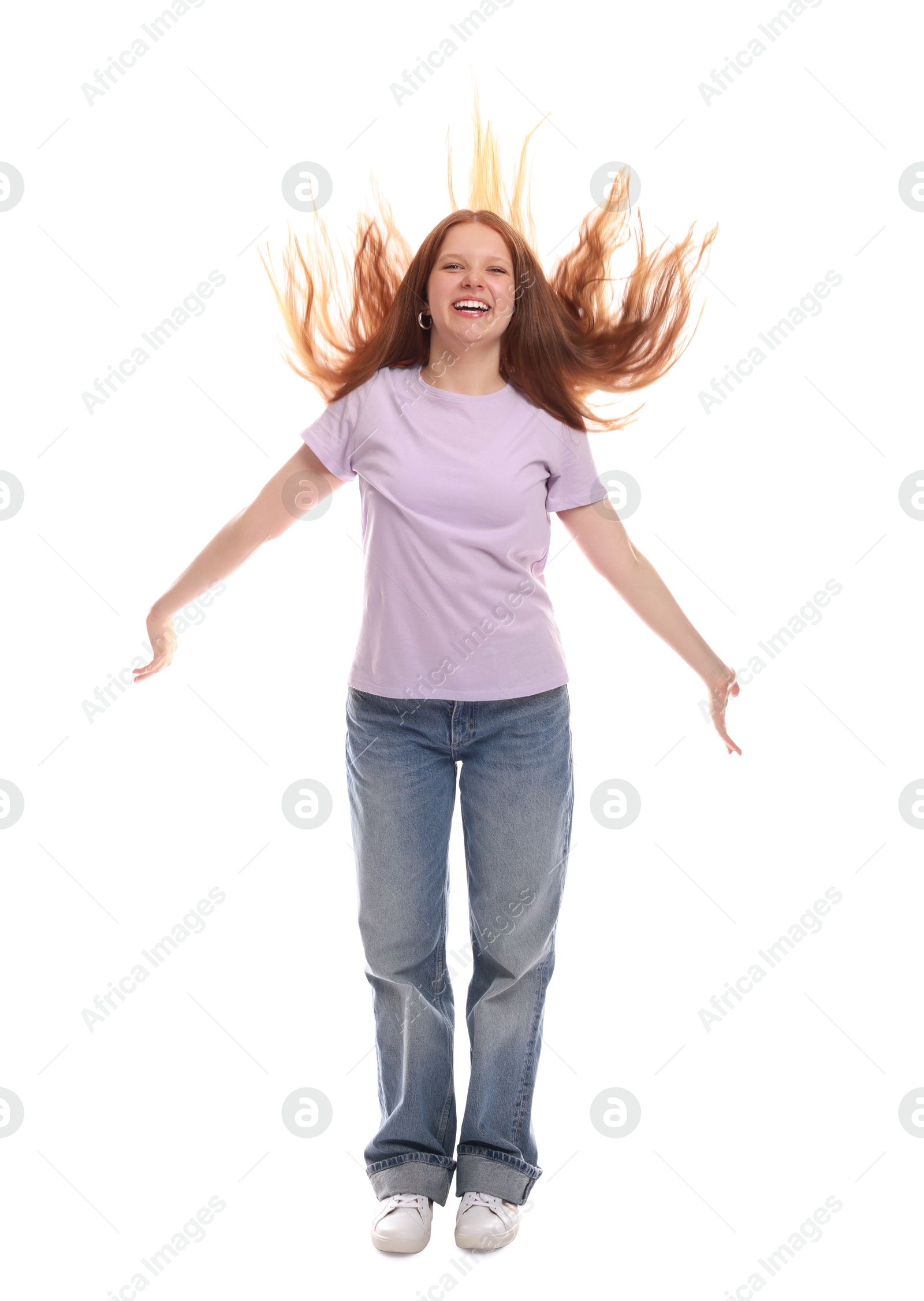 Photo of Positive teenage girl jumping on white background