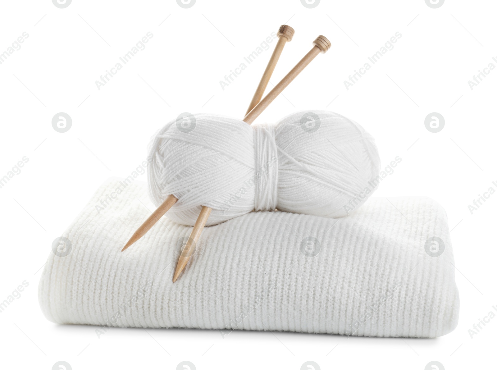 Photo of Skein of yarn with knitting needles and sweater isolated on white