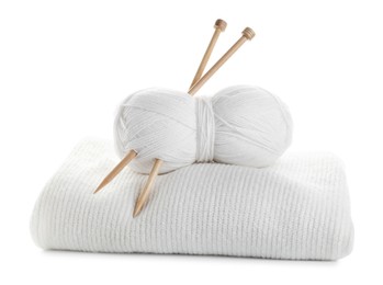 Skein of yarn with knitting needles and sweater isolated on white