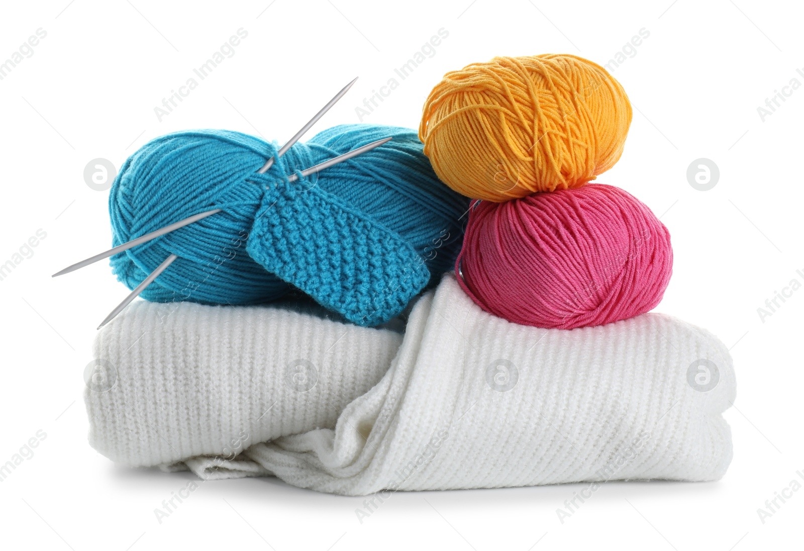 Photo of Different yarns, knitting needles, pattern sample and sweaters isolated on white