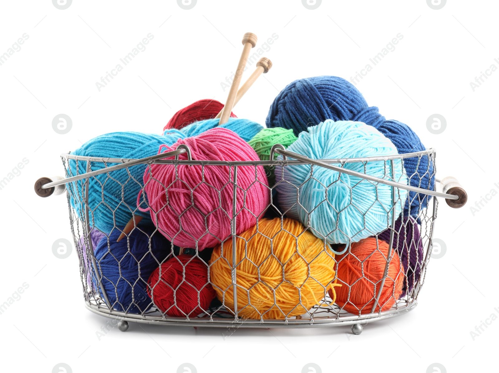 Photo of Metal basket with bright yarns and knitting needles isolated on white