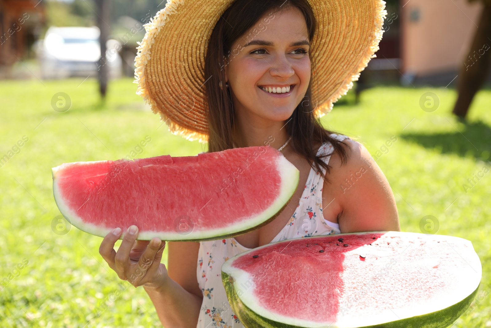 Photo of Happy woman with fresh juicy watermelon outdoors