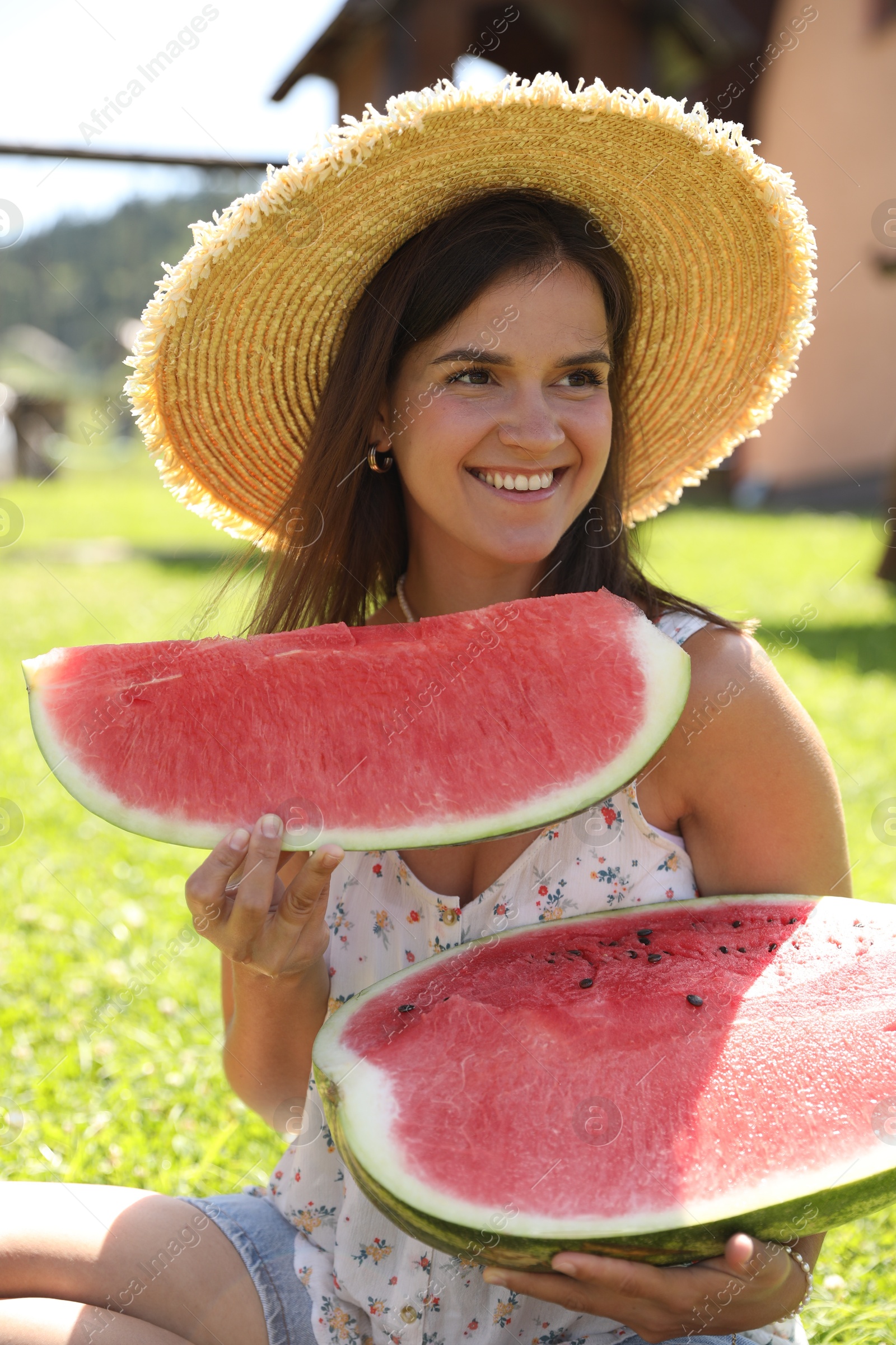 Photo of Happy woman with fresh juicy watermelon outdoors