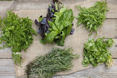 Photo of Different fresh herbs on wooden table, flat lay