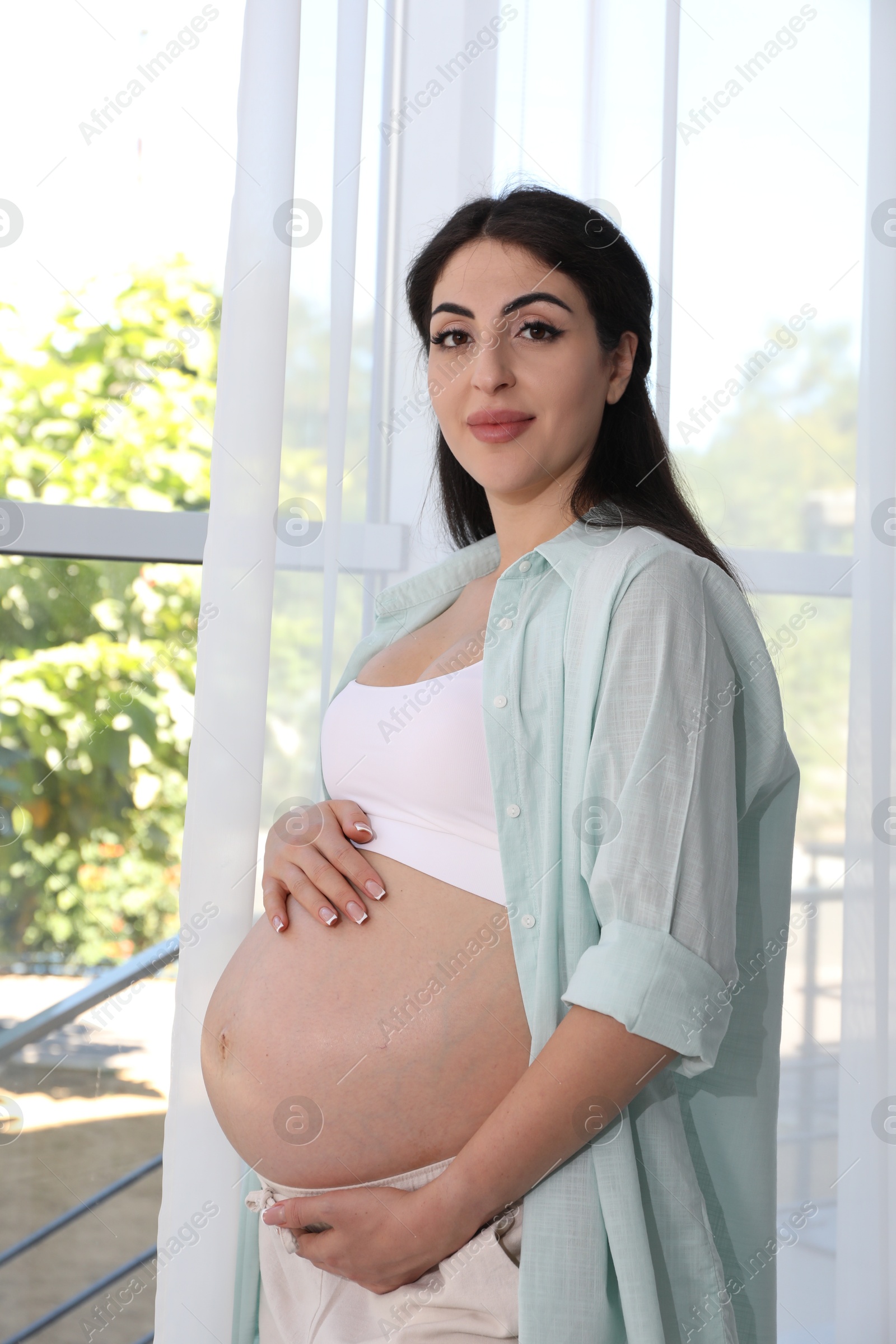 Photo of Portrait of beautiful pregnant woman at home