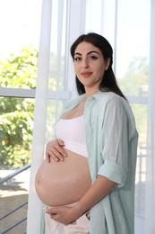 Photo of Portrait of beautiful pregnant woman at home