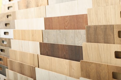 Photo of Many different samples of wooden flooring in store, closeup