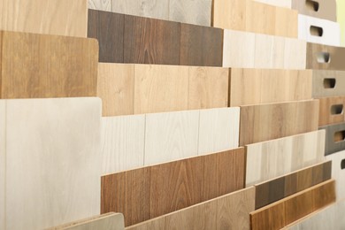 Photo of Many different samples of wooden flooring in store, closeup