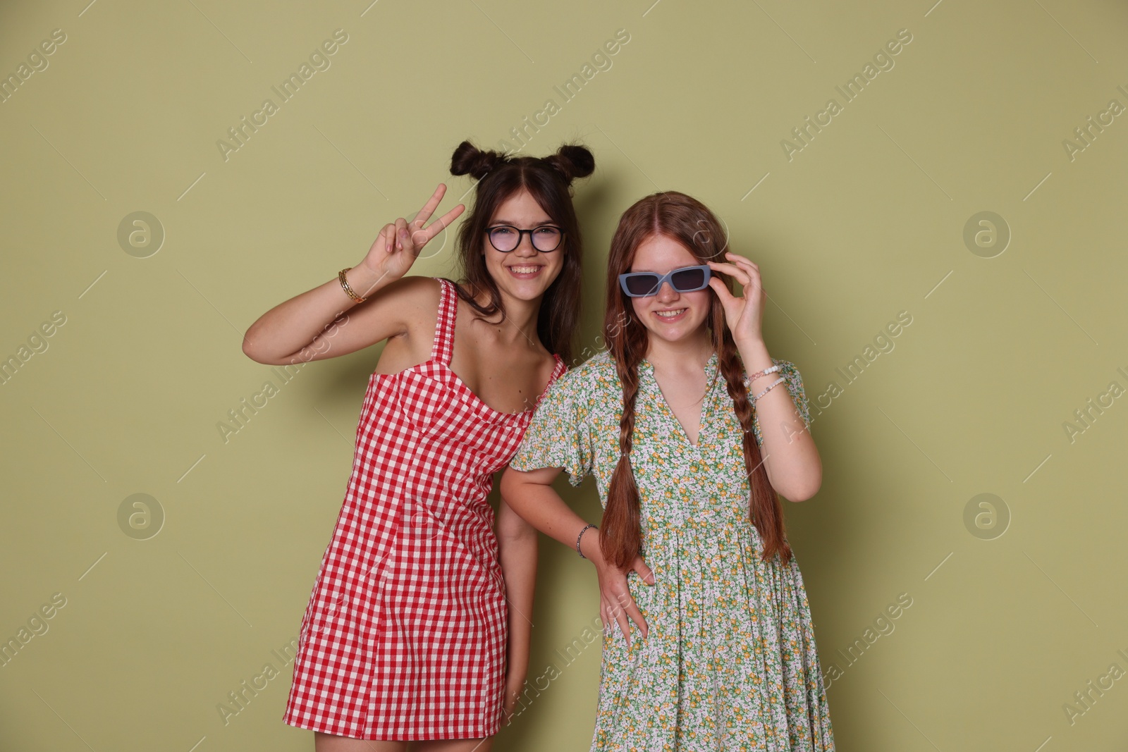 Photo of Happy teenage girls posing on green background