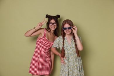 Happy teenage girls posing on green background