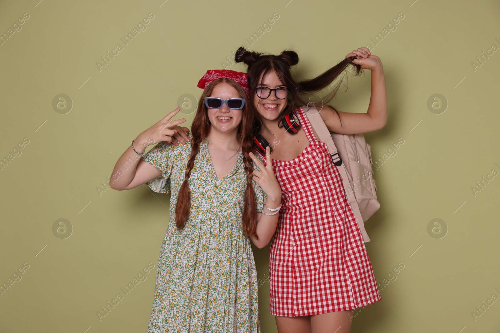 Photo of Happy teenage girls posing on green background