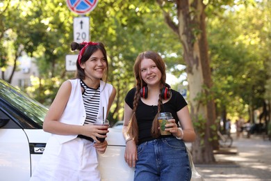 Photo of Happy teenage friends spending time together outdoors