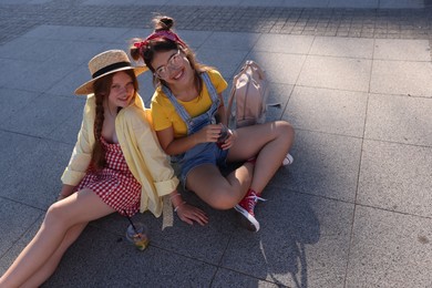 Photo of Happy teenage friends posing on city street. Space for text