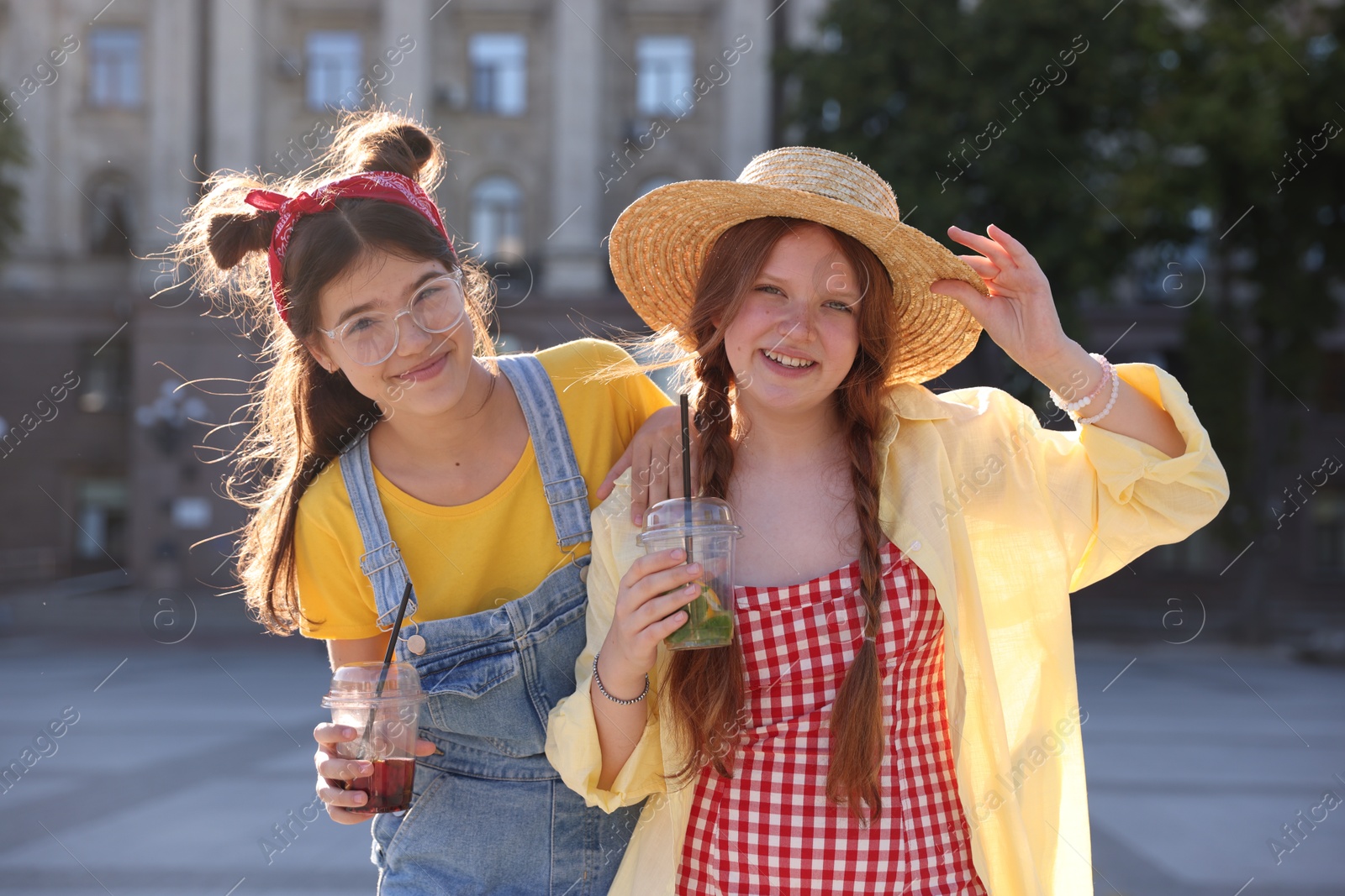 Photo of Happy teenage friends posing on city street