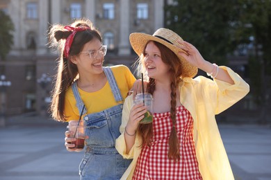 Photo of Happy teenage friends posing on city street