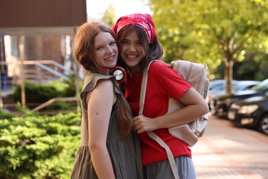 Photo of Portrait of happy teenage friends on city street