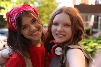 Photo of Portrait of happy teenage friends on city street