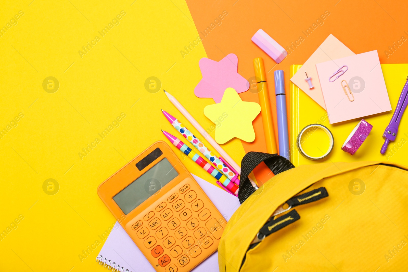 Photo of Backpack and different school stationery on color background, flat lay. Space for text