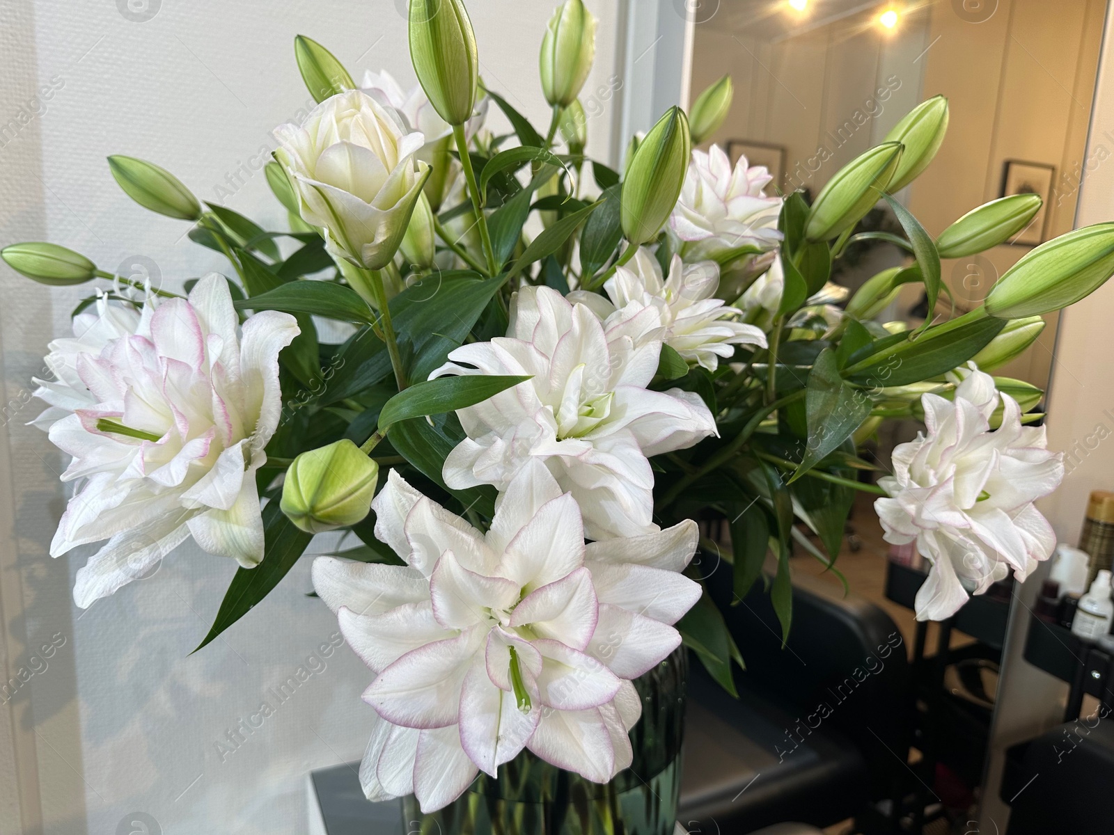 Photo of Bouquet of beautiful flowers on table indoors