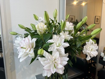 Photo of Bouquet of beautiful flowers on table indoors