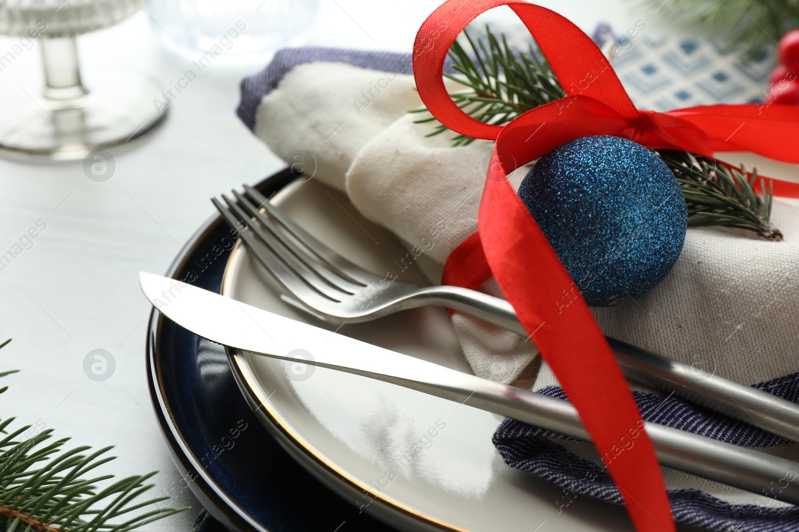 Photo of Christmas table setting with festive decor, closeup