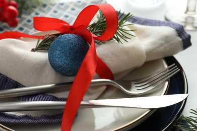 Photo of Christmas table setting with festive decor, closeup