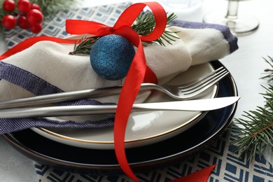 Photo of Christmas table setting with festive decor, closeup