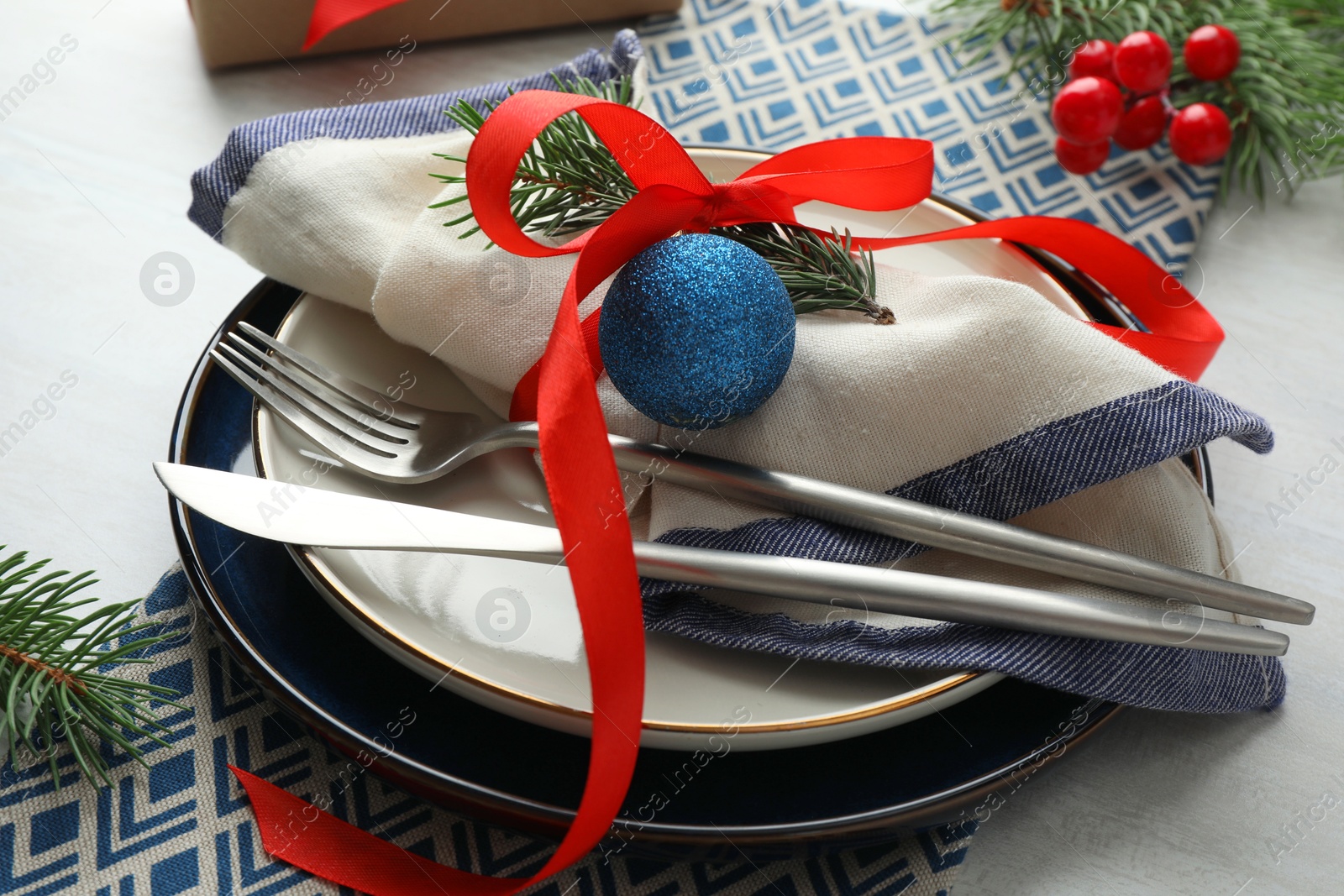 Photo of Christmas table setting with festive decor, closeup