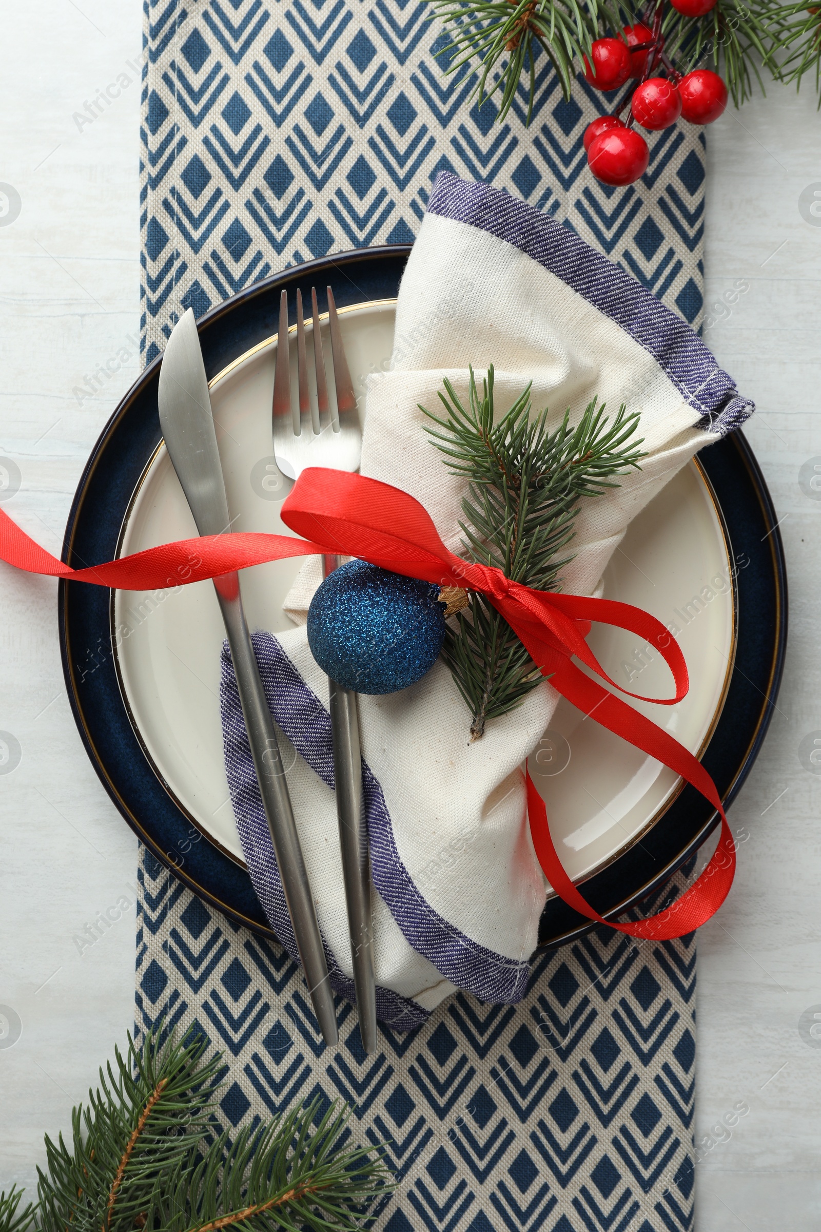 Photo of Christmas table setting with festive decor, flat lay