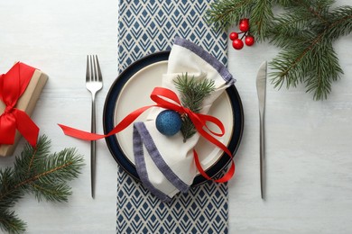 Photo of Christmas table setting with festive decor, flat lay