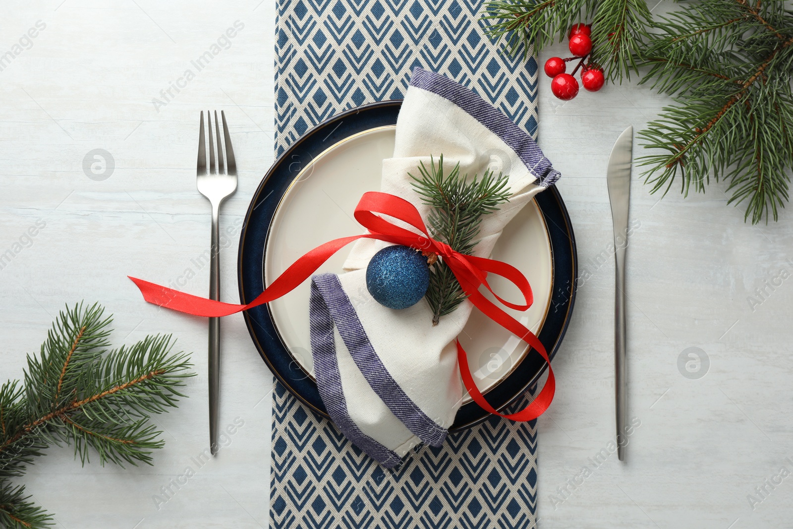 Photo of Christmas table setting with festive decor, flat lay