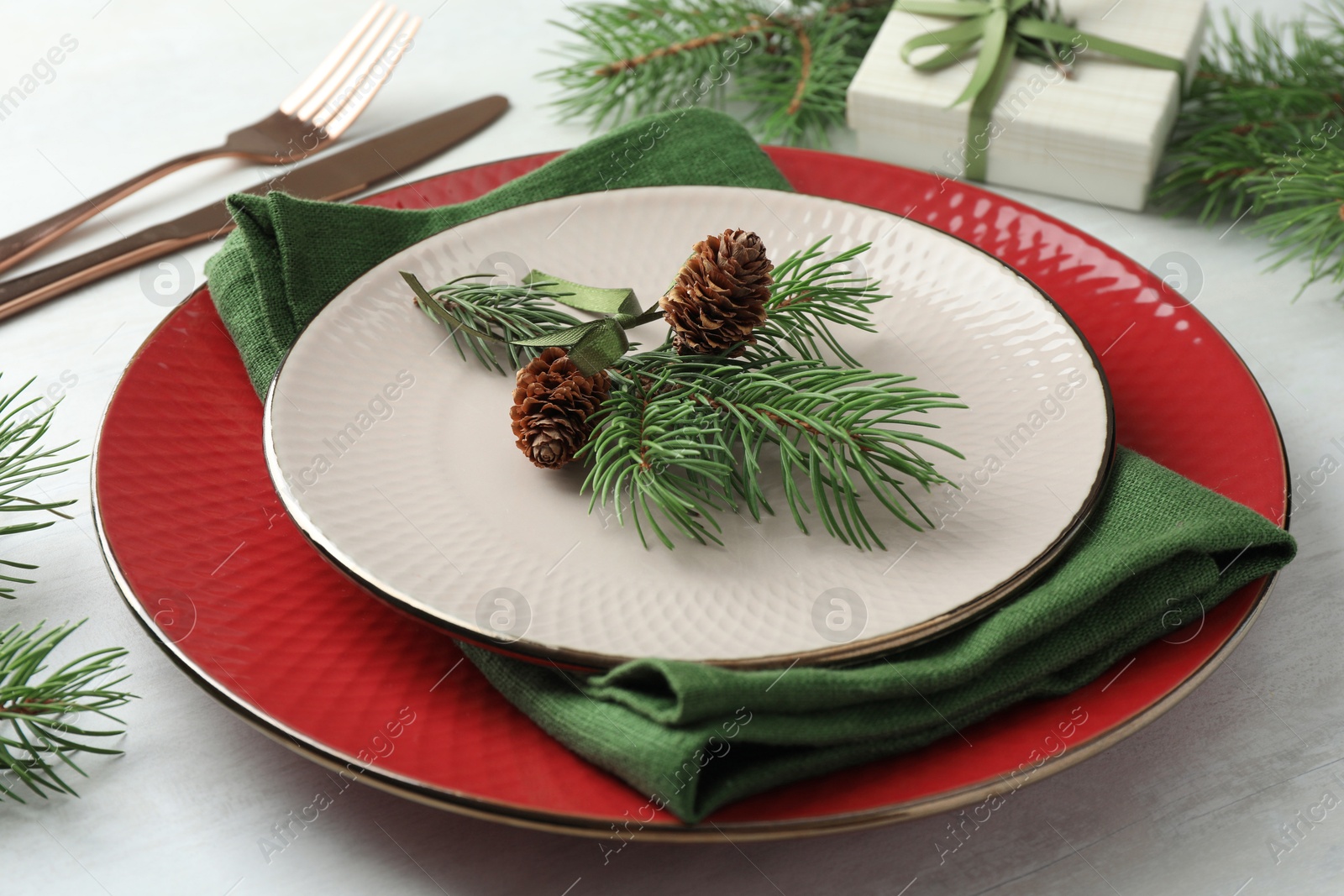 Photo of Christmas table setting with festive decor, closeup