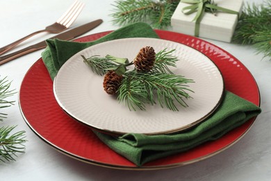 Photo of Christmas table setting with festive decor, closeup