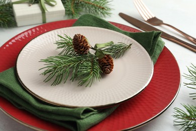 Photo of Christmas table setting with festive decor, closeup