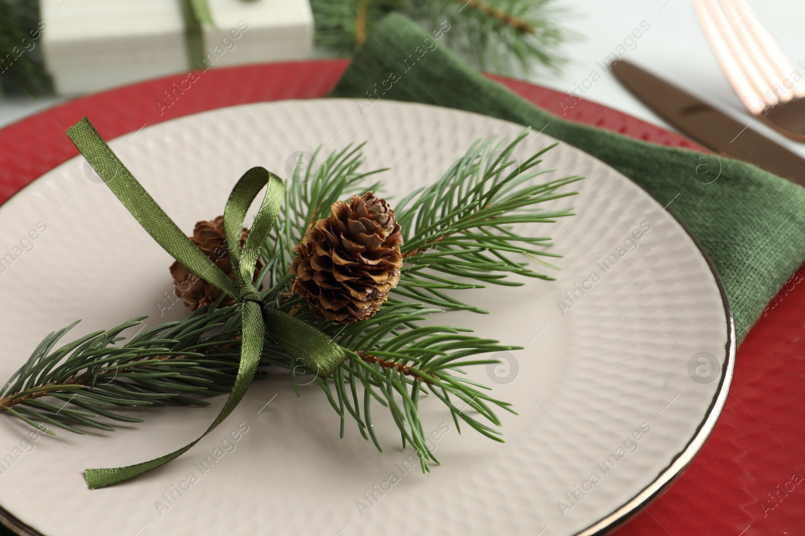 Photo of Christmas table setting with festive decor, closeup