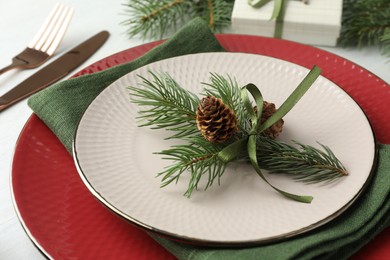 Photo of Christmas table setting with festive decor, closeup