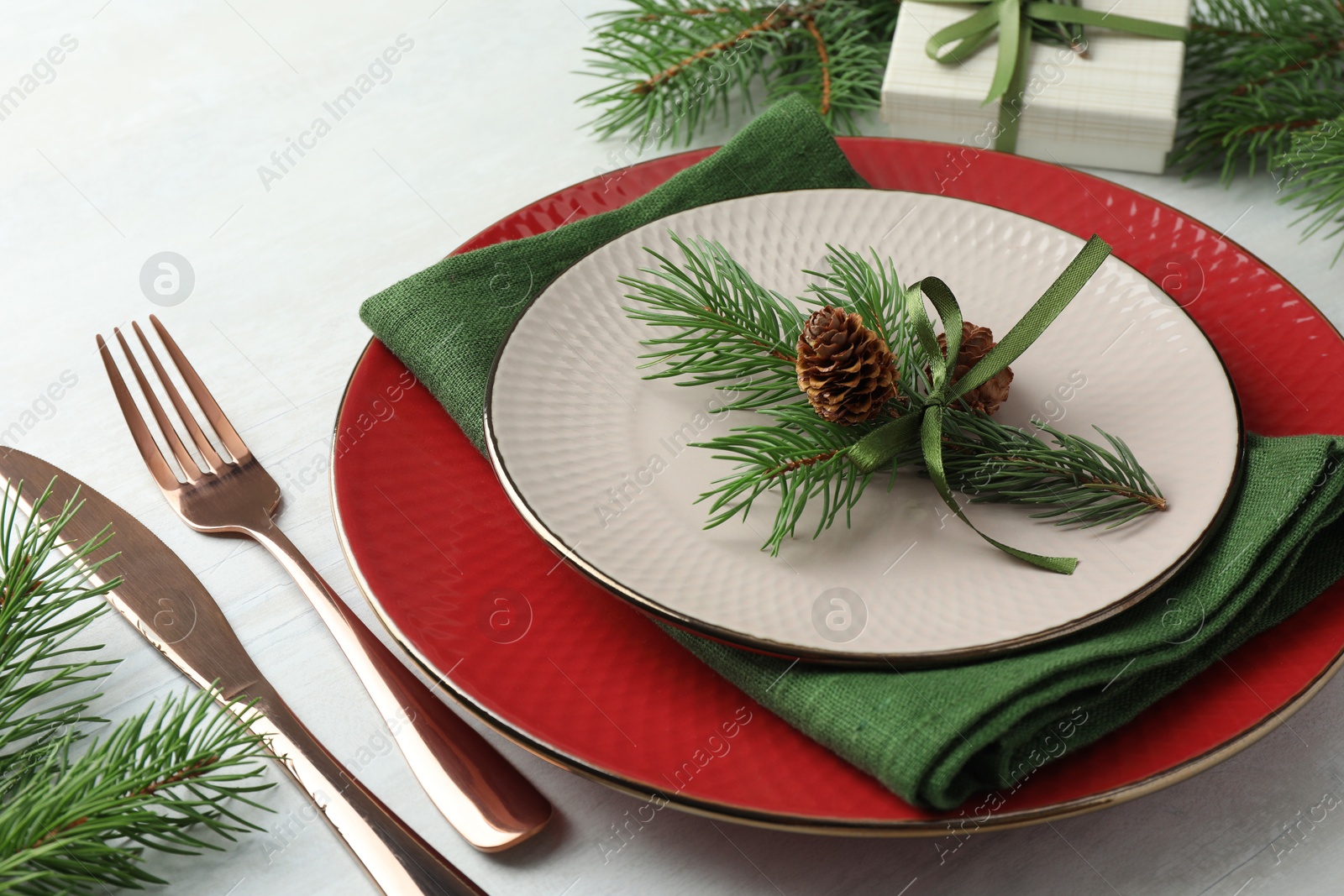 Photo of Christmas table setting with festive decor, closeup