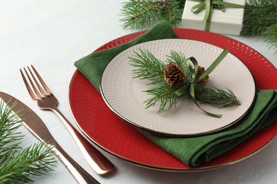 Photo of Christmas table setting with festive decor, closeup