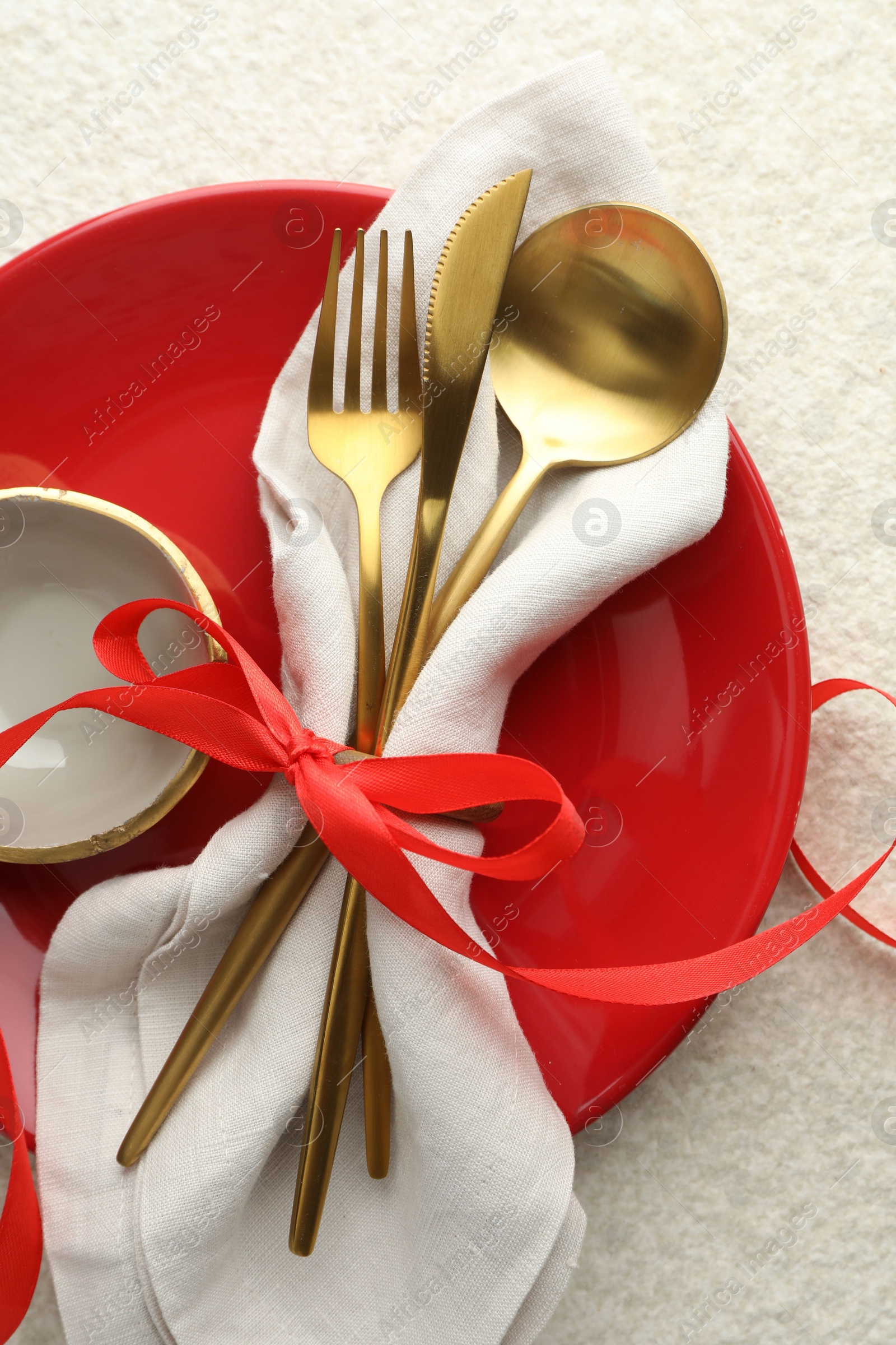 Photo of Christmas table setting with bowl, plate and cutlery, top view