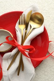 Photo of Christmas table setting with bowl, plate and cutlery, top view