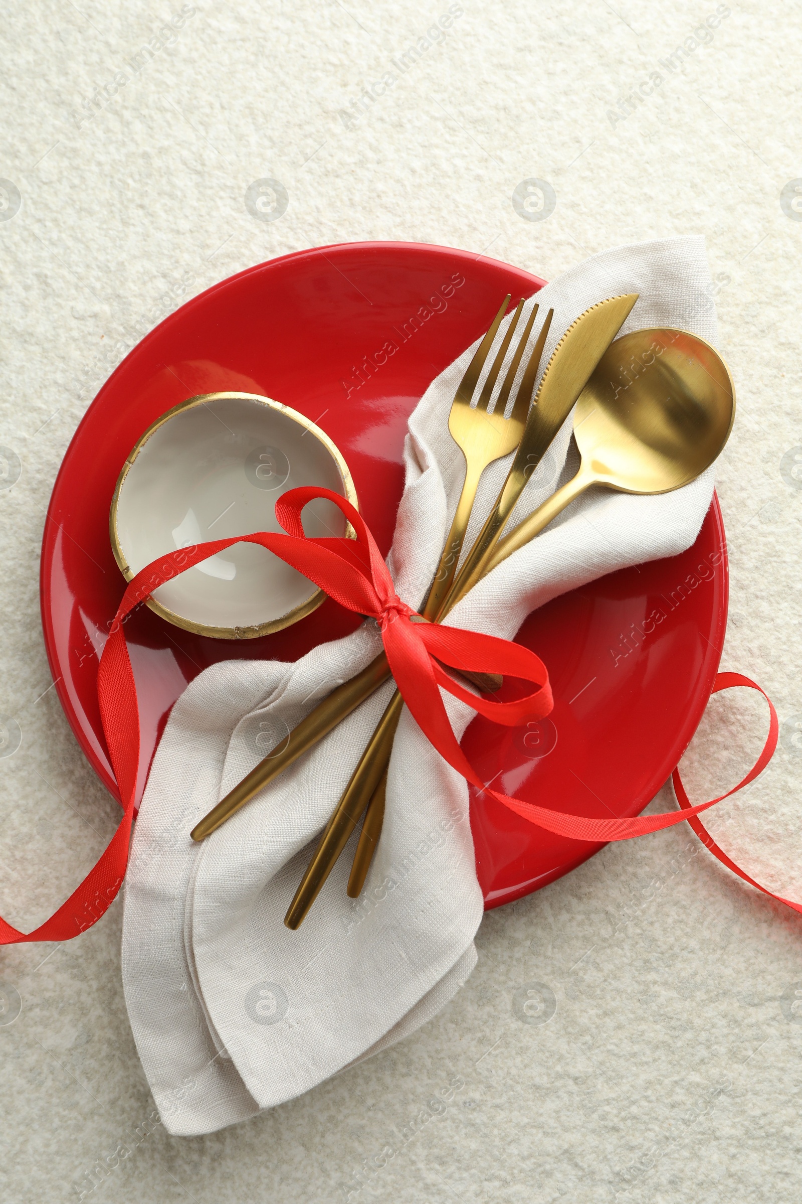 Photo of Christmas table setting with bowl, plate and cutlery, top view